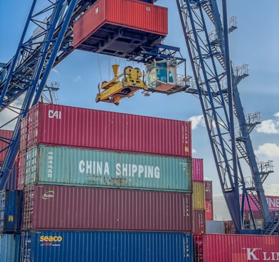 a crane is lifting a container onto a truck