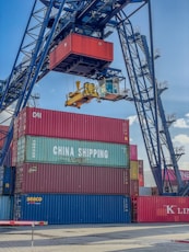 a crane is lifting a container onto a truck