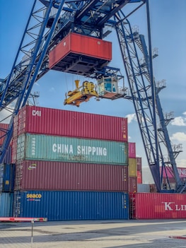 a crane is lifting a container onto a truck