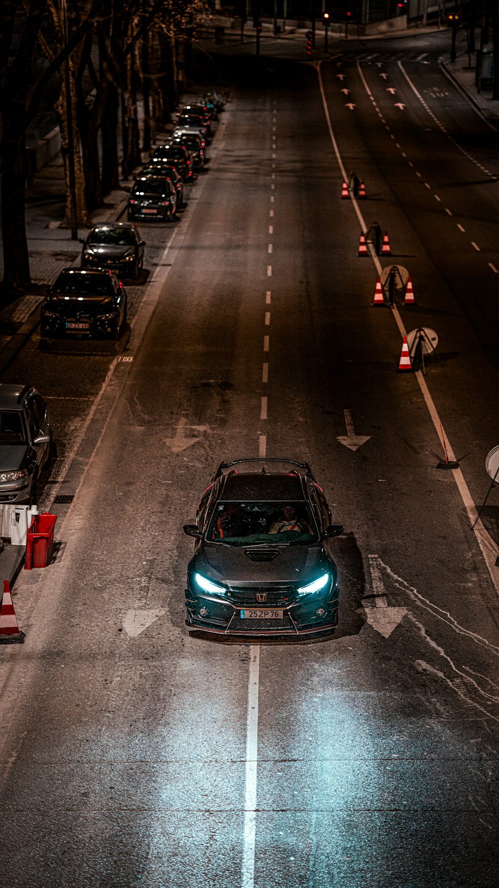 a car driving down a street at night