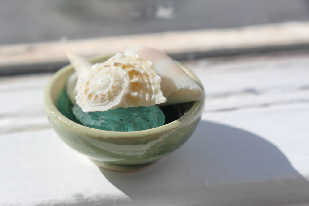 a small green bowl filled with ice cream