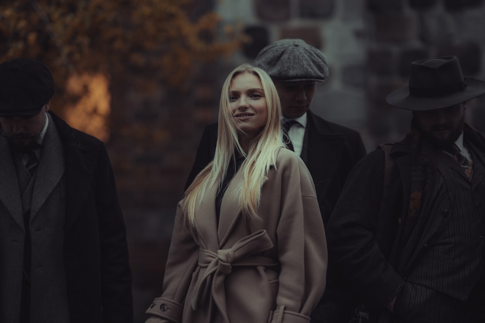 a woman in a trench coat and a man in a hat