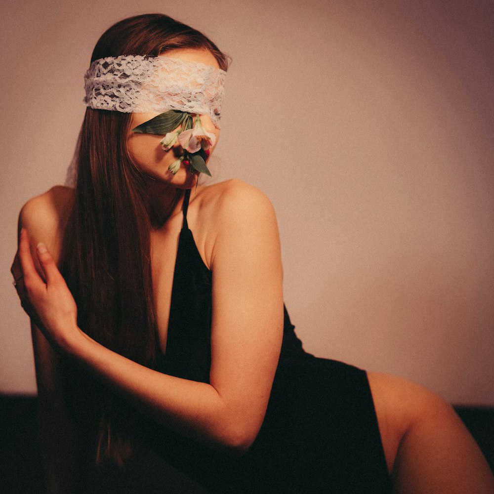 a woman with a blindfold on her face