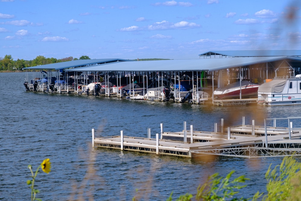 a boat dock with several boats parked on it