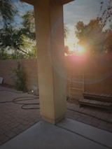 A completed paver patio glowing warmly in the late afternoon light.