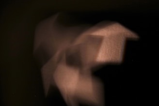 Soft charcoal background with subtle AI glow and abstract shapes.