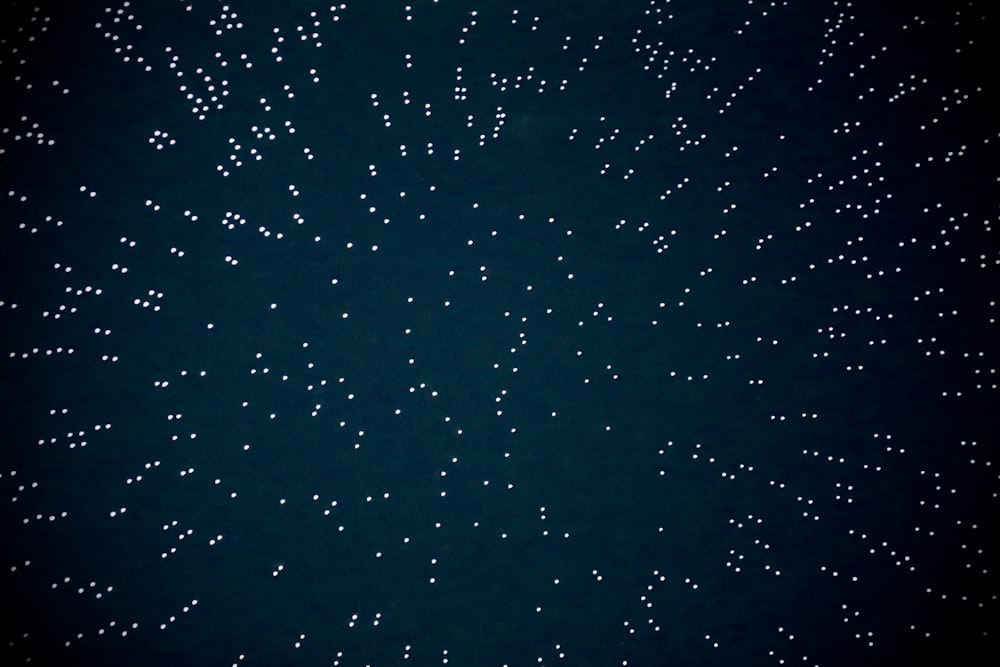 a black background with white stars in the sky