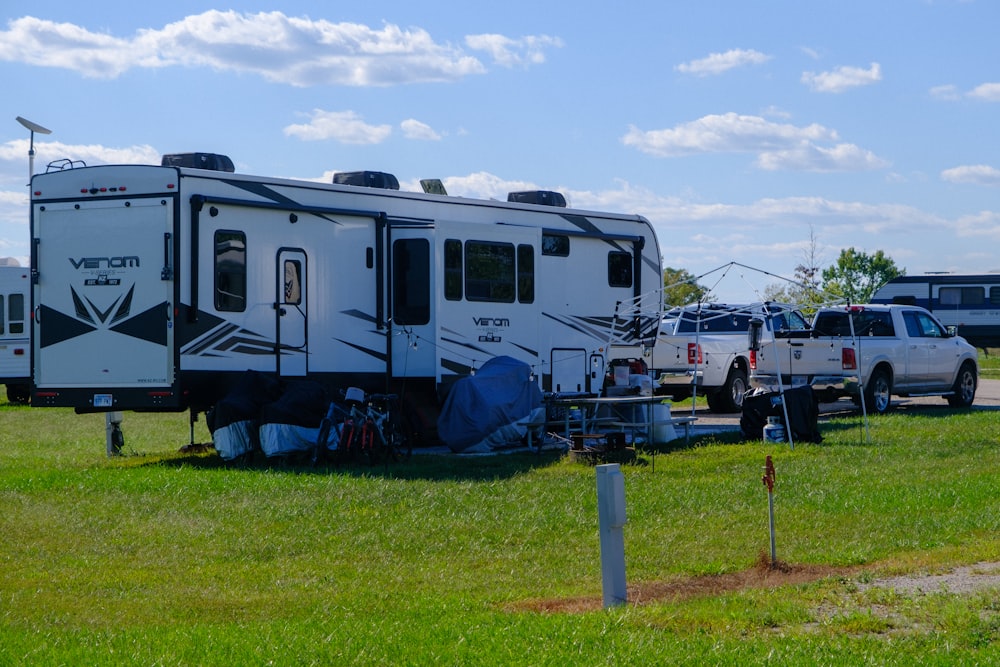 a camper parked in a field next to a truck