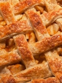 A close-up of a classic apple pie with a golden, flaky crust.