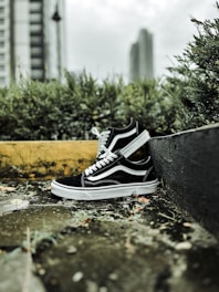 A pair of sleek sneakers resting on a city sidewalk.