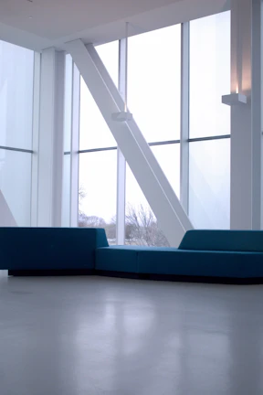 Spacious bedroom with floor-to-ceiling windows and minimalist Italian furniture.