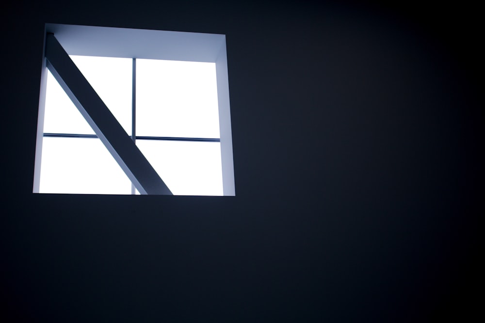 a window in a dark room with the light coming in