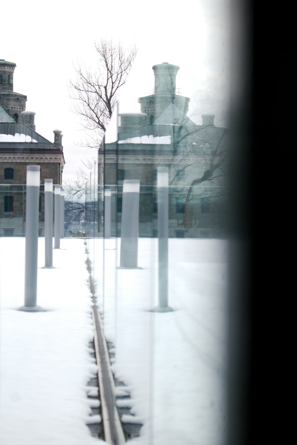 a row of white poles sitting next to a building