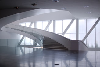 a staircase in a building with large windows