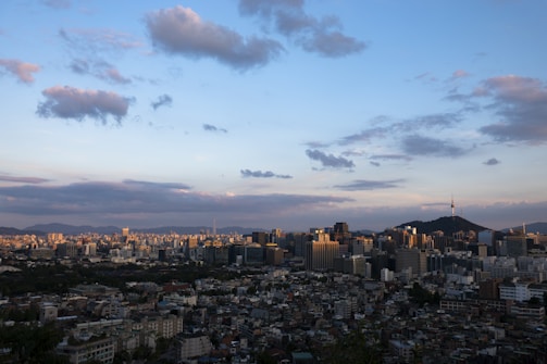 A panoramic view of a bustling Mumbai skyline at dusk, highlighting urban growth.