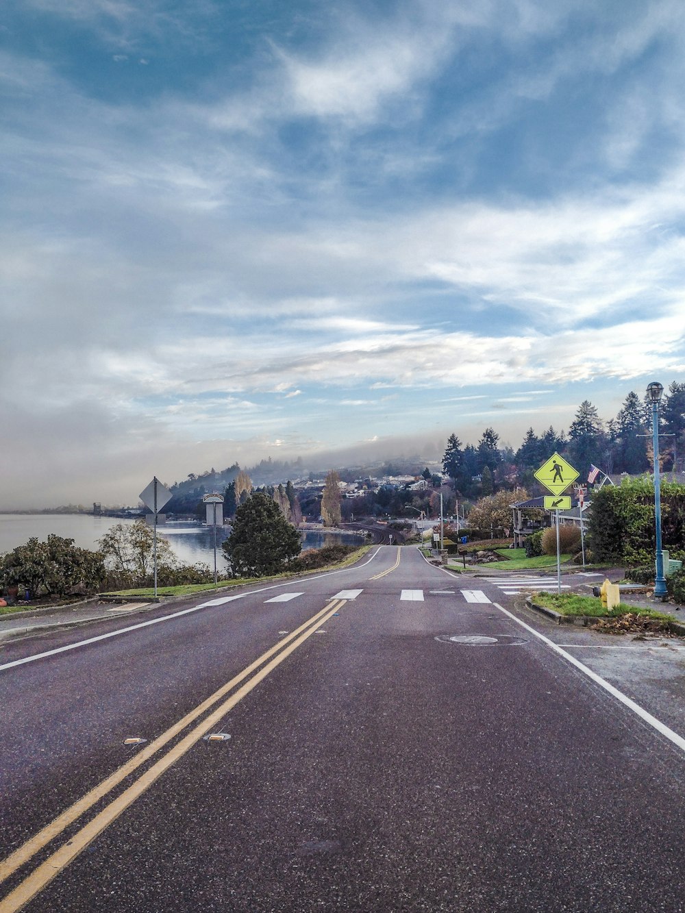 an empty street with a sign on the side of it