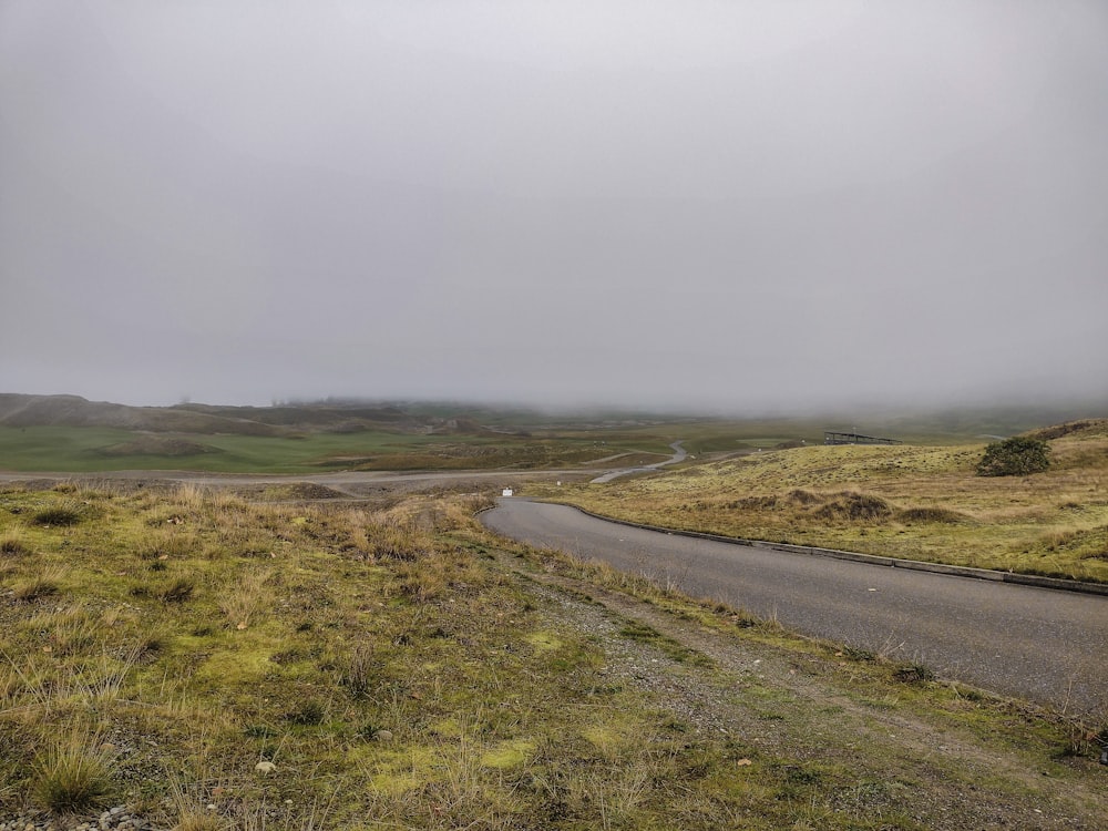 a road in the middle of a grassy field