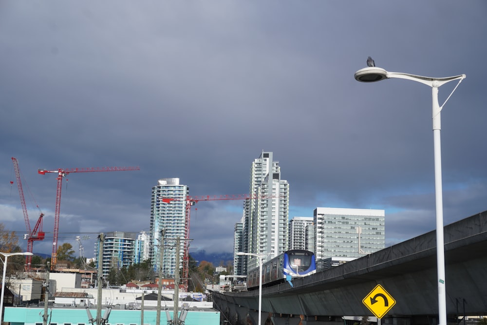 a street light on a city street with tall buildings in the background