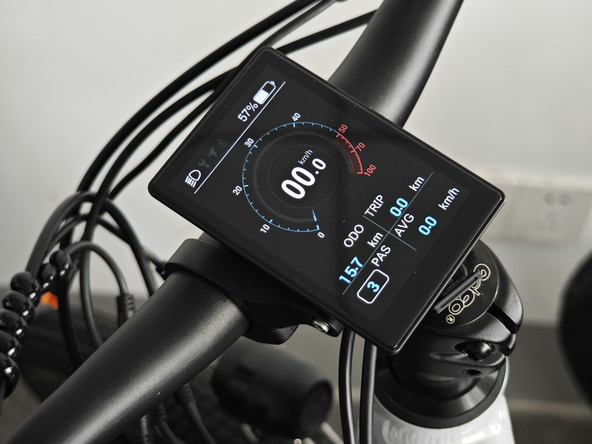 Close-up of an electric bike's sleek handlebar and digital display panel under natural sunlight