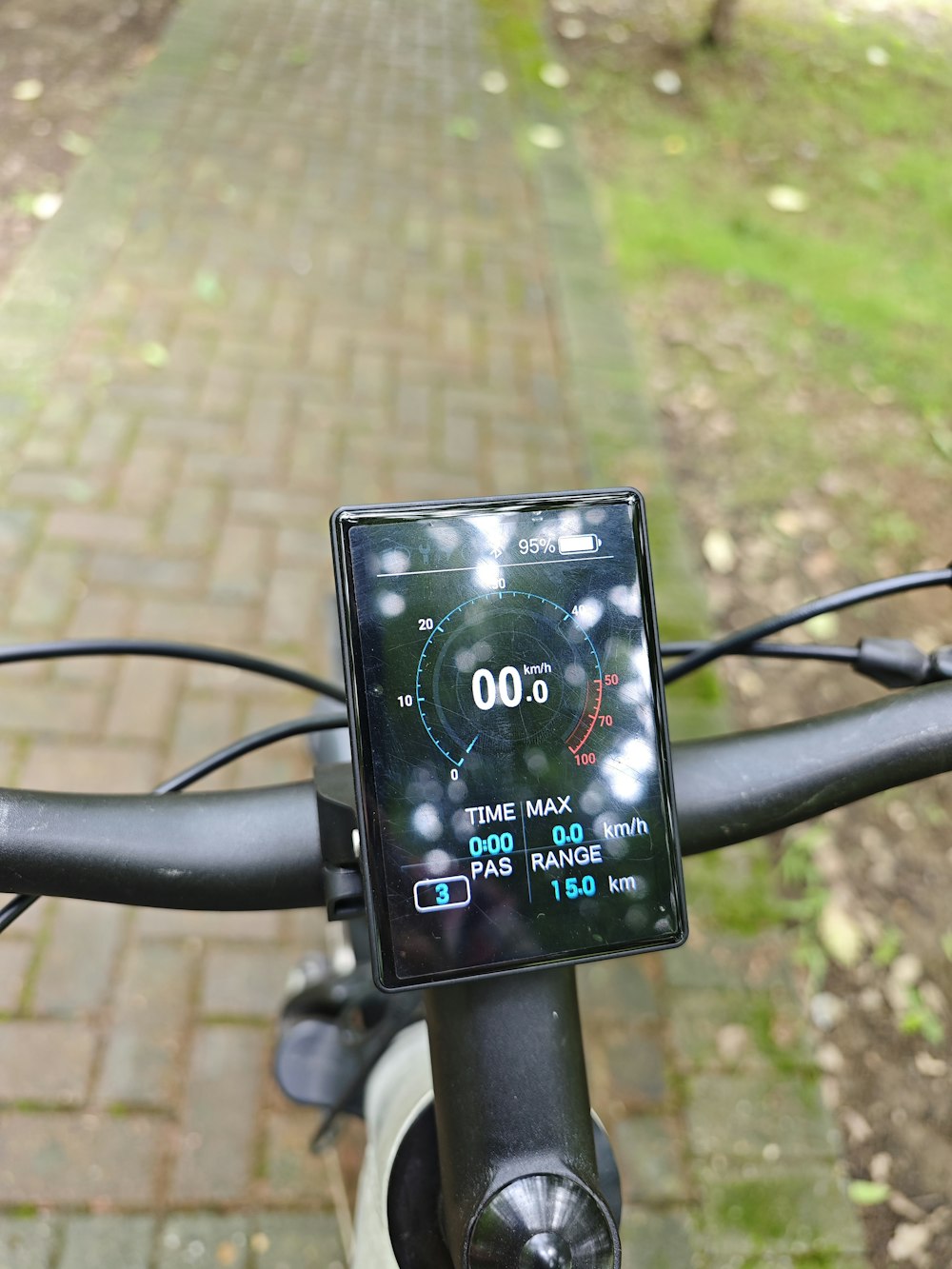 a close up of a bike handle bar with a clock on it