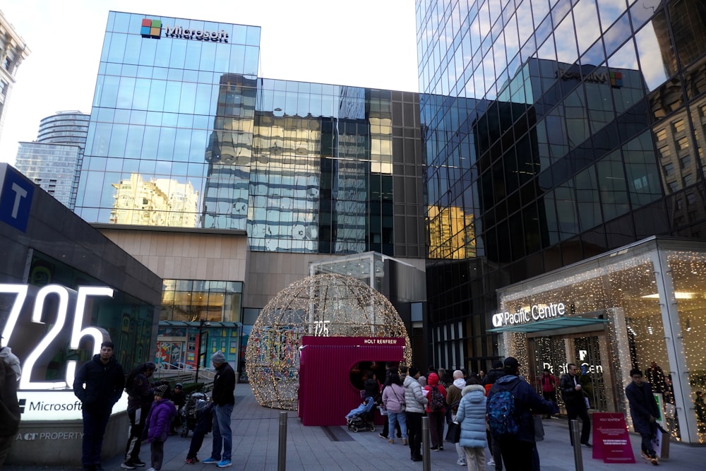 a group of people walking around a shopping mall