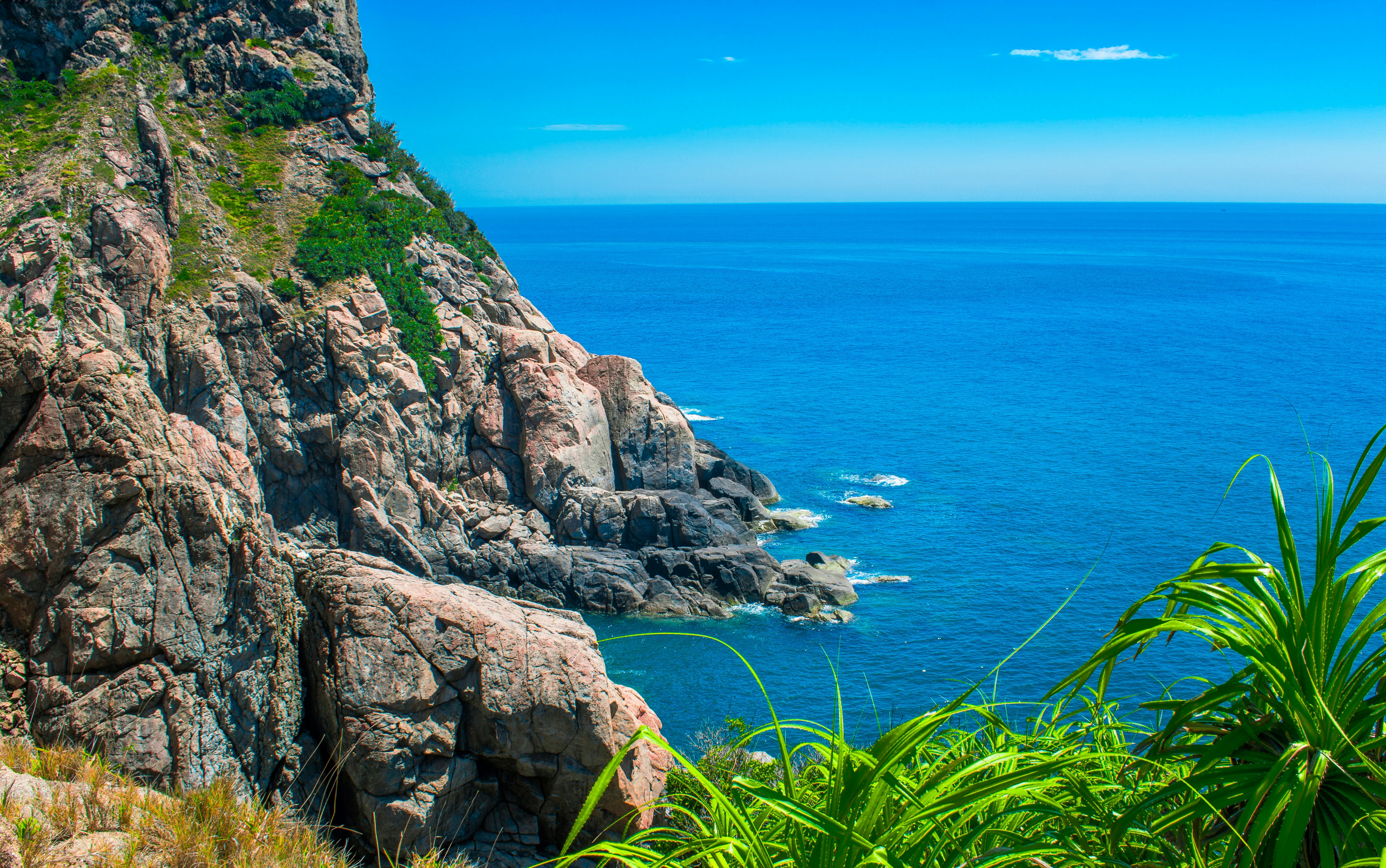 a view of the ocean from the top of a mountain, 