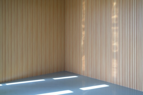 A serene studio corner with blue ceramic tiles and natural light filtering through.