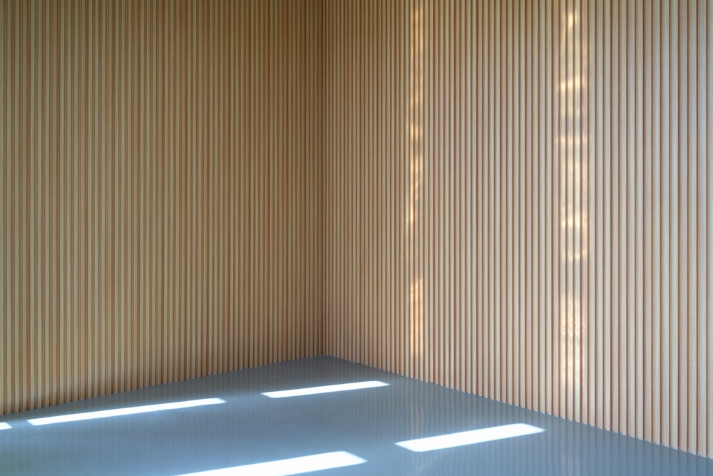 a room with a wall that has vertical blinds on it