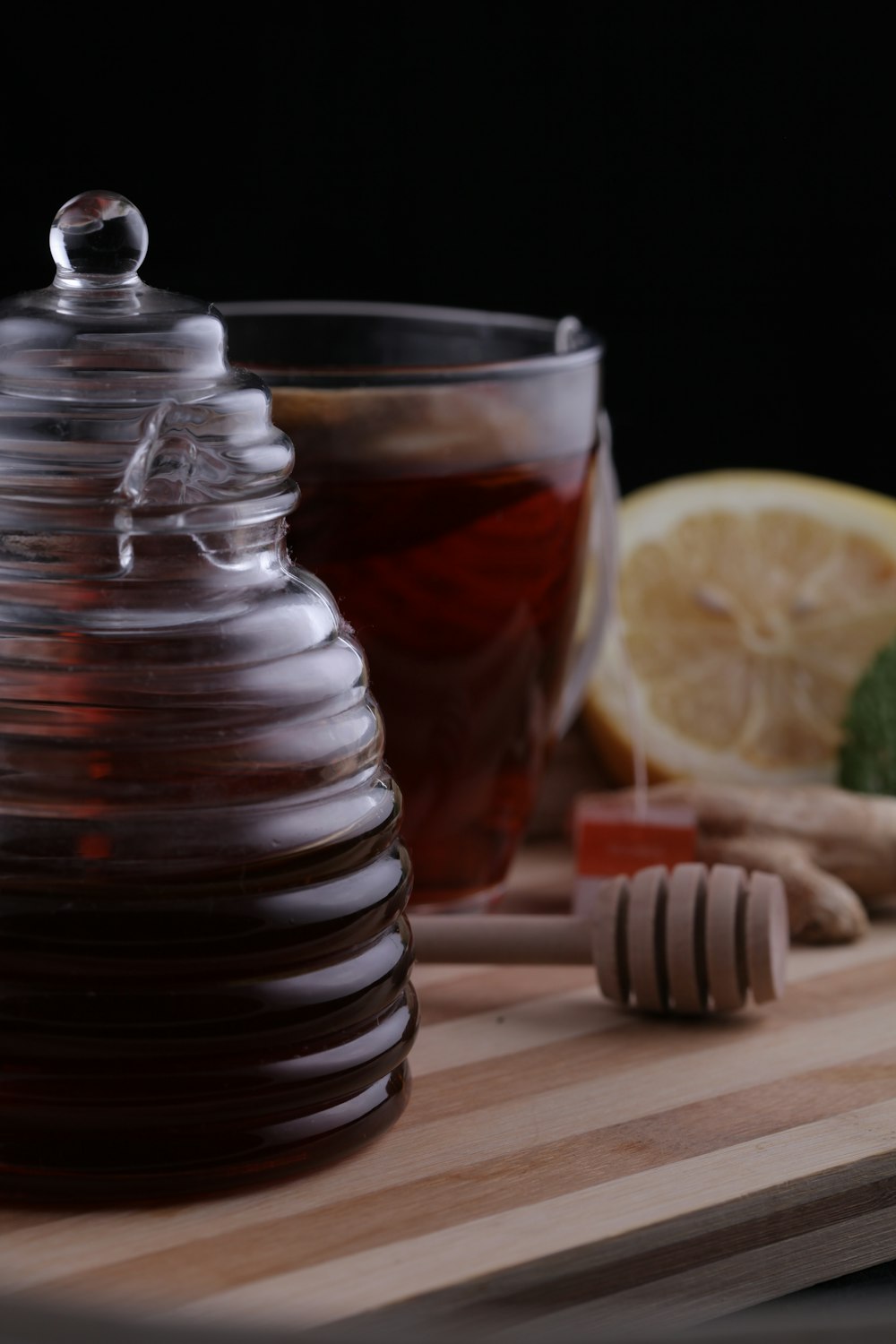 a pitcher of tea next to a cup of tea