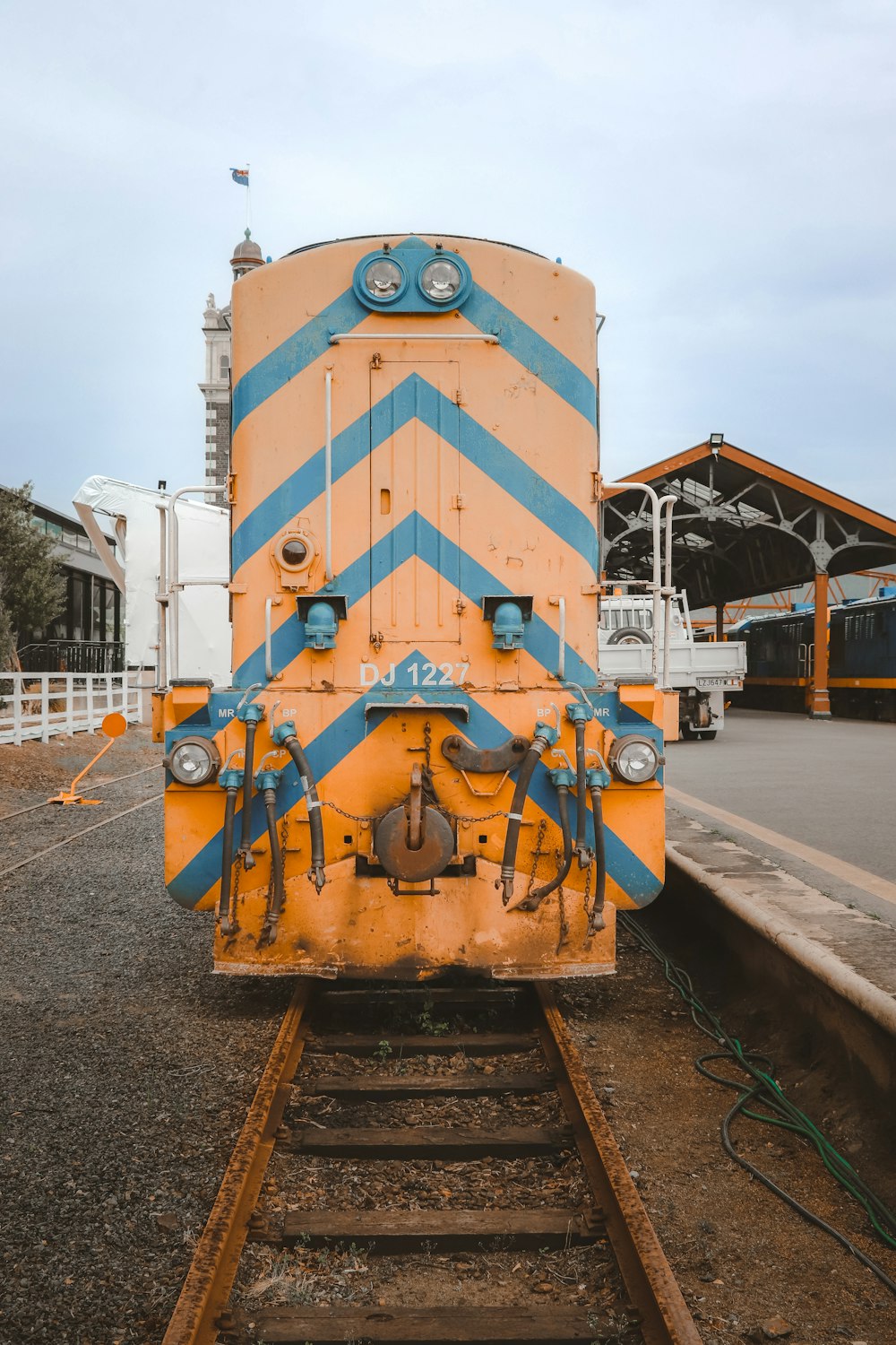 a yellow and blue train sitting on the tracks