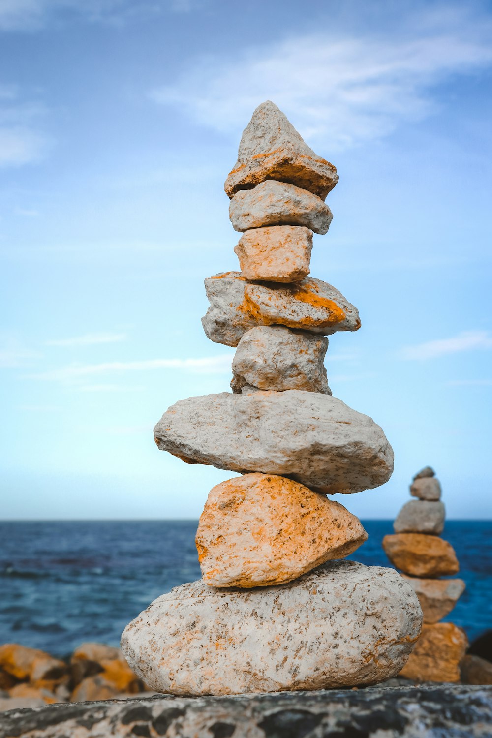 a stack of rocks sitting on top of a beach