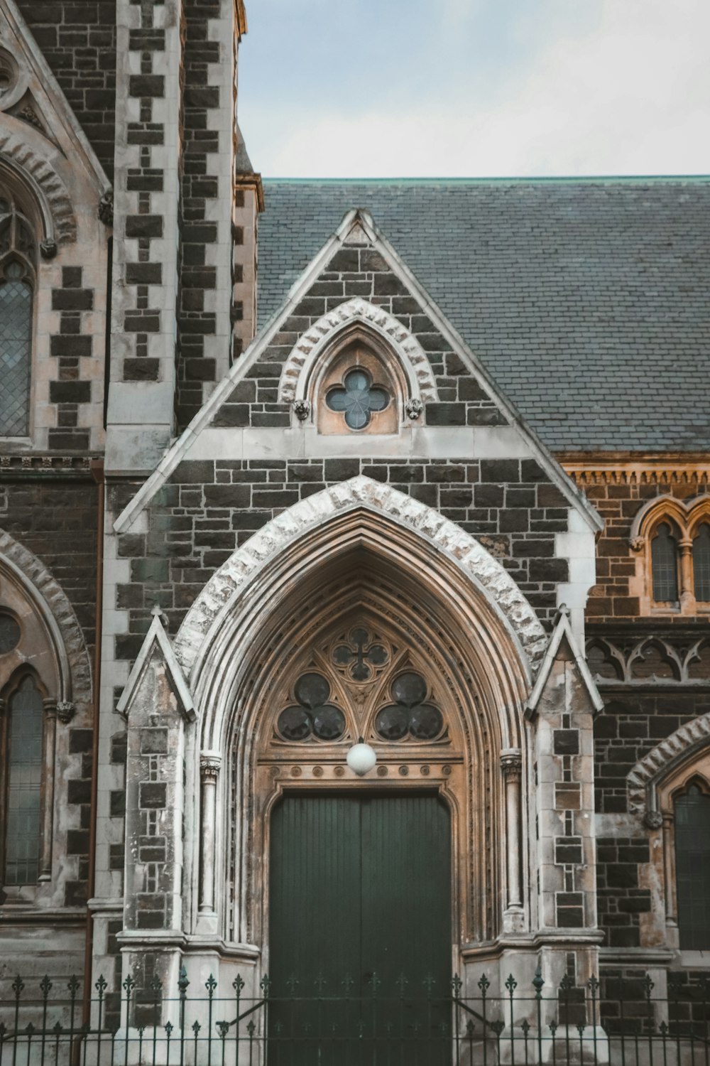 an old church with a large green door