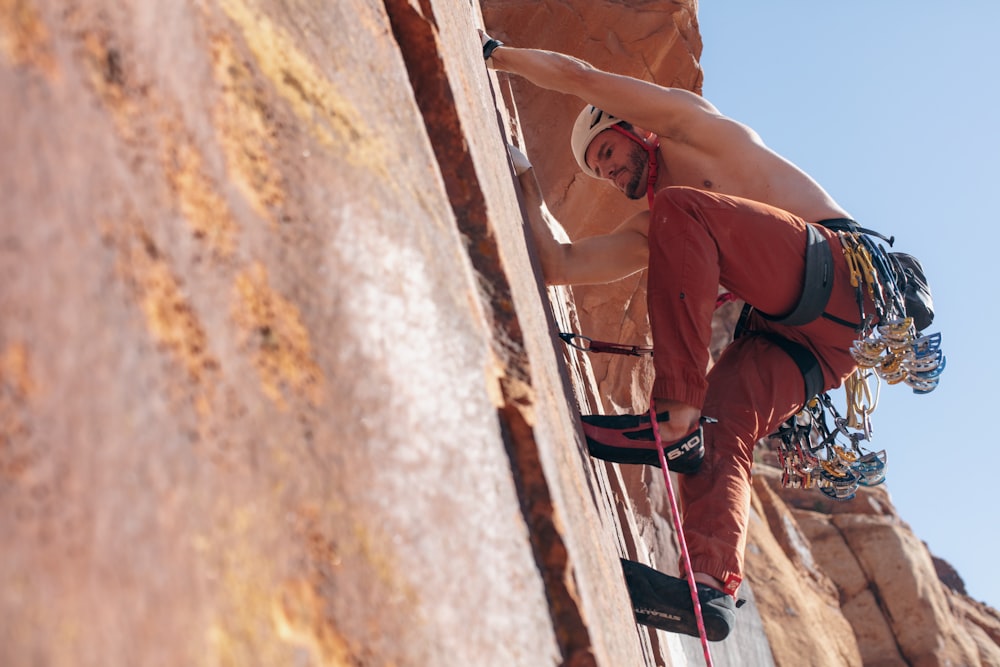 a man climbing up the side of a cliff