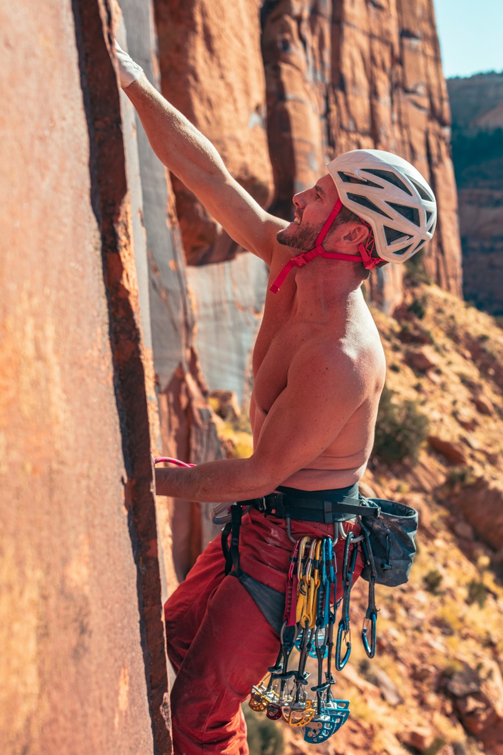 un uomo che si arrampica sul fianco di una montagna