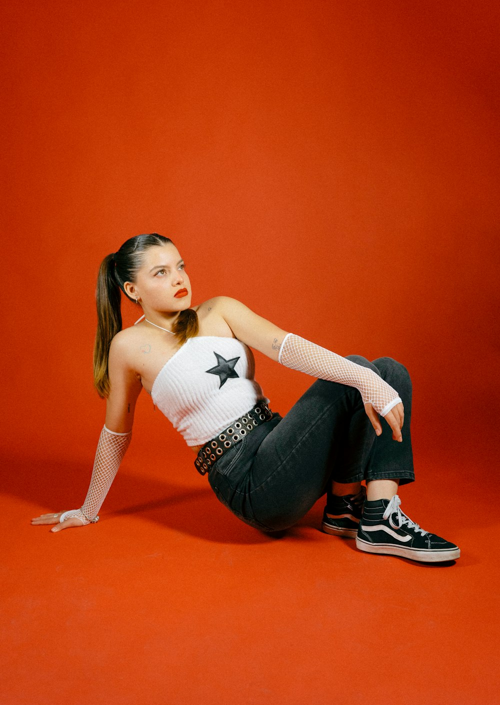 a woman sitting on the ground with her legs crossed