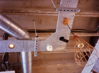 A cluster of industrial retro pendant lights hanging from a rustic ceiling beam.