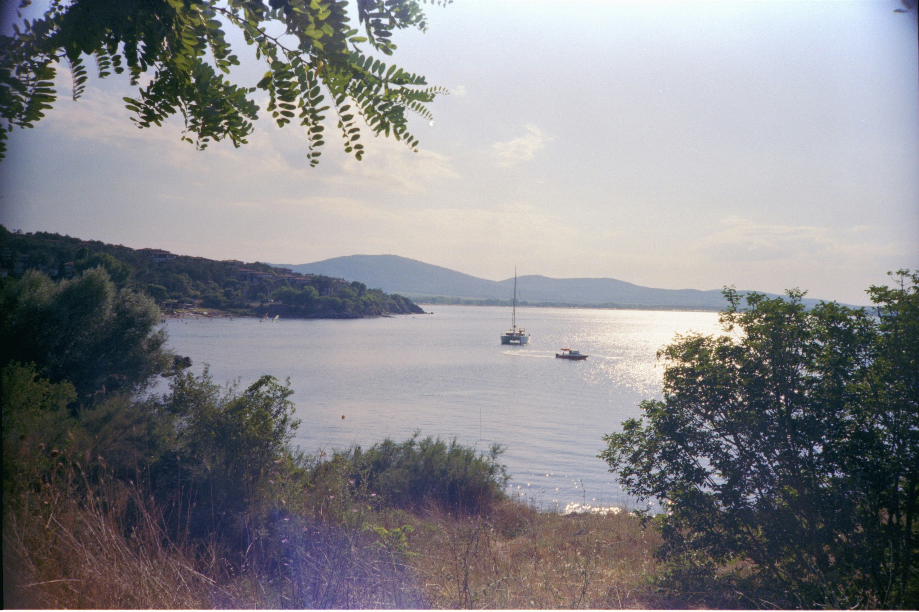 a boat is out on the water near the shore