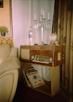 A cozy corner with a vintage radio and a steaming cup of coffee, inviting quiet reflection.