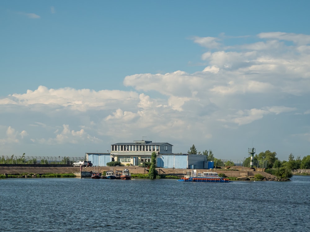 a large body of water with a building in the background