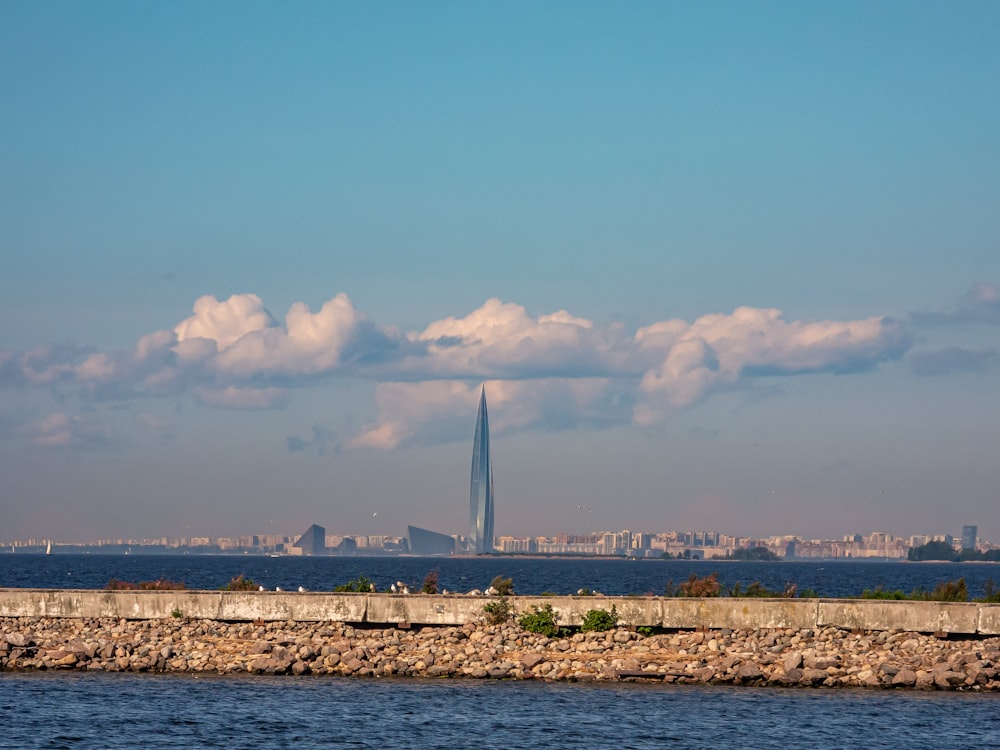 a large body of water with a tall building in the background