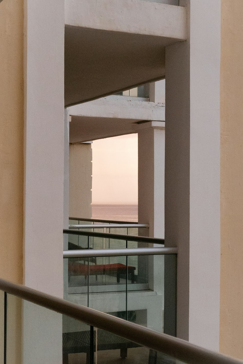 a balcony with a railing and a view of the ocean