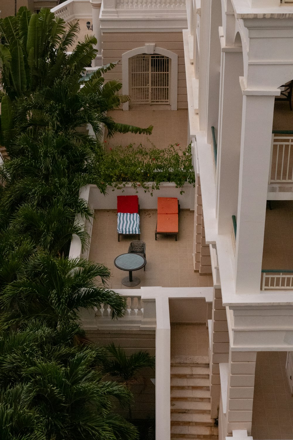 an aerial view of a building with a red chair and a blue table