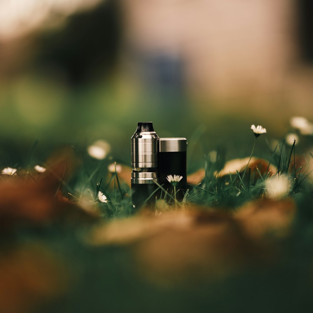 a camera sitting on top of a lush green field