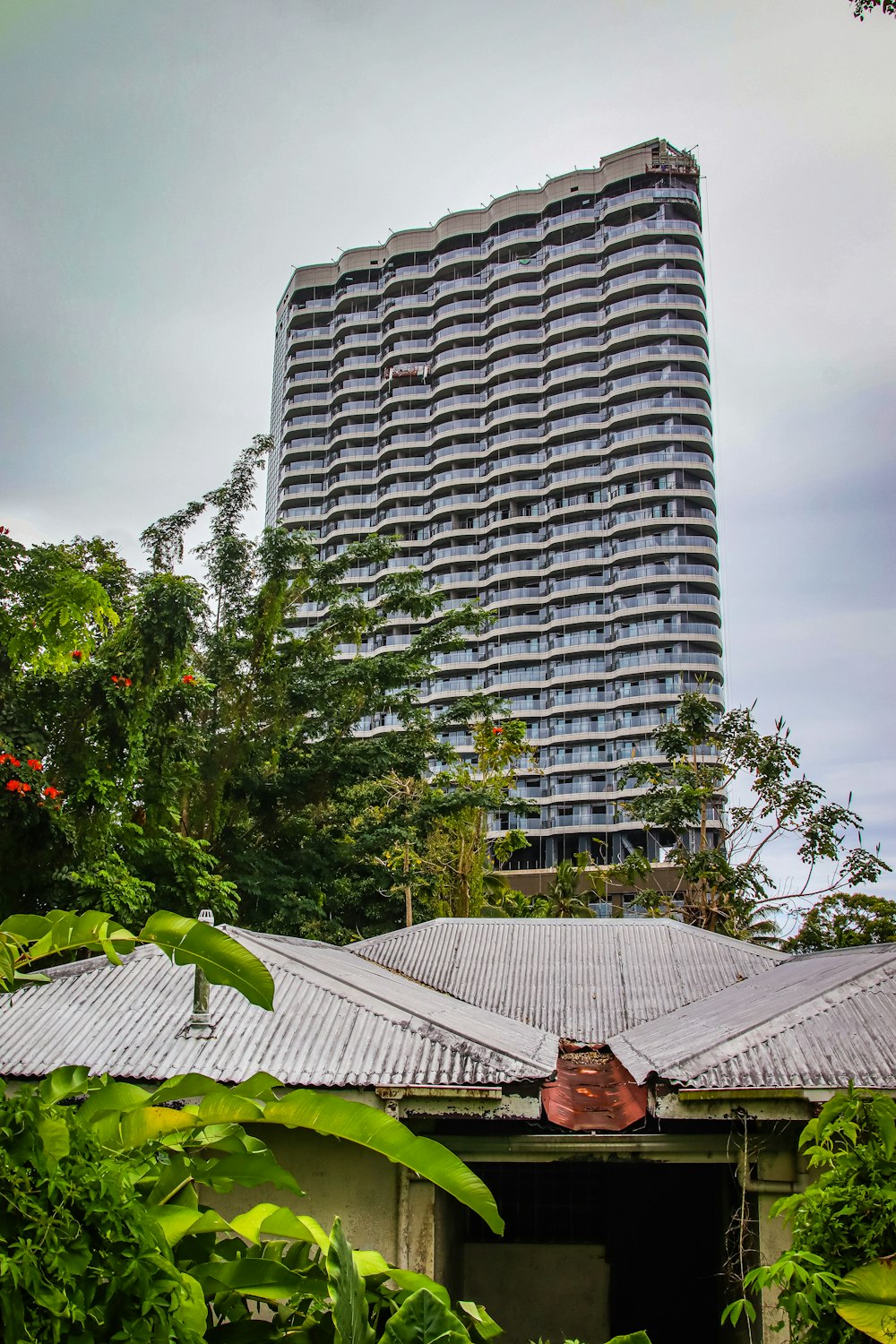 a very tall building sitting in the middle of a forest