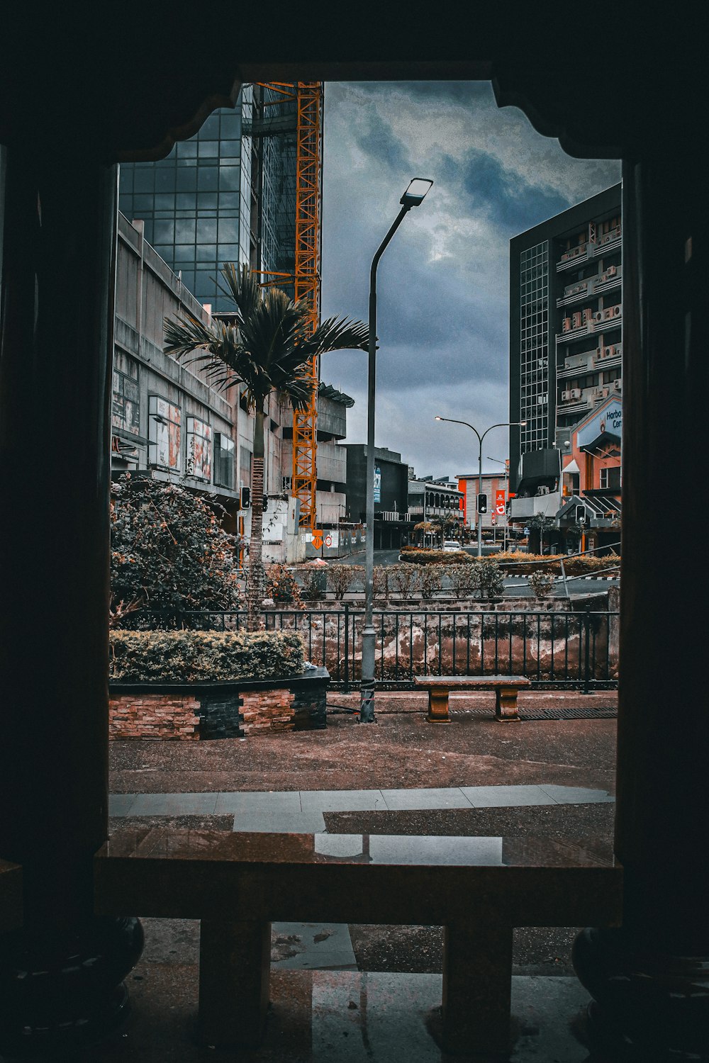 a wooden bench sitting in front of a tall building