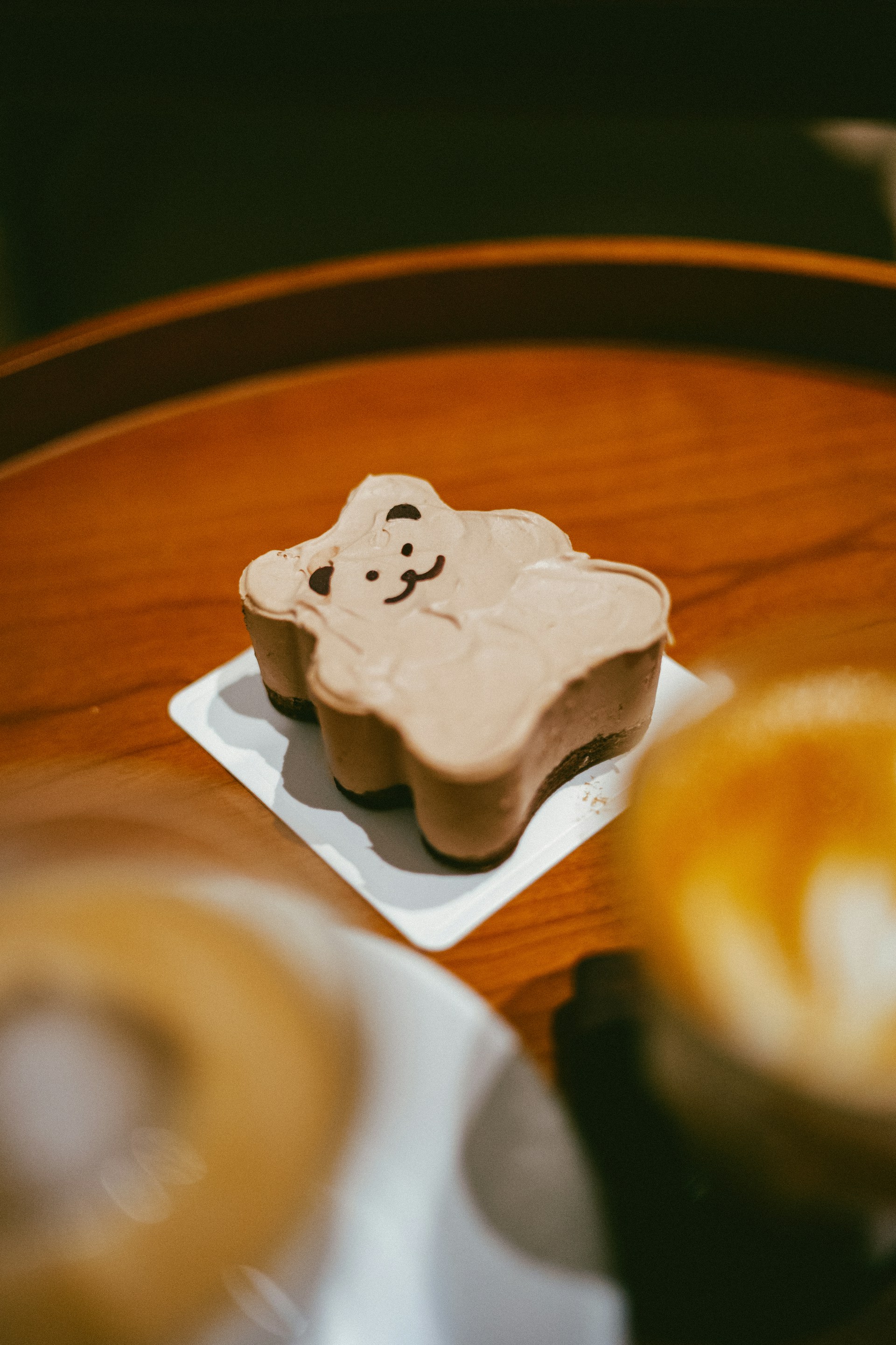 An adorable kawaii image of a cup filled with natural yogurt soft serve, decorated with playful toppings and a small panda character beside it.