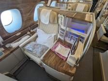the inside of an airplane with a bed and a desk