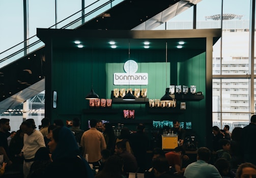 A bustling local café with new signage and happy customers.