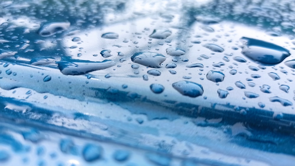 a close up of water droplets on a blue surface