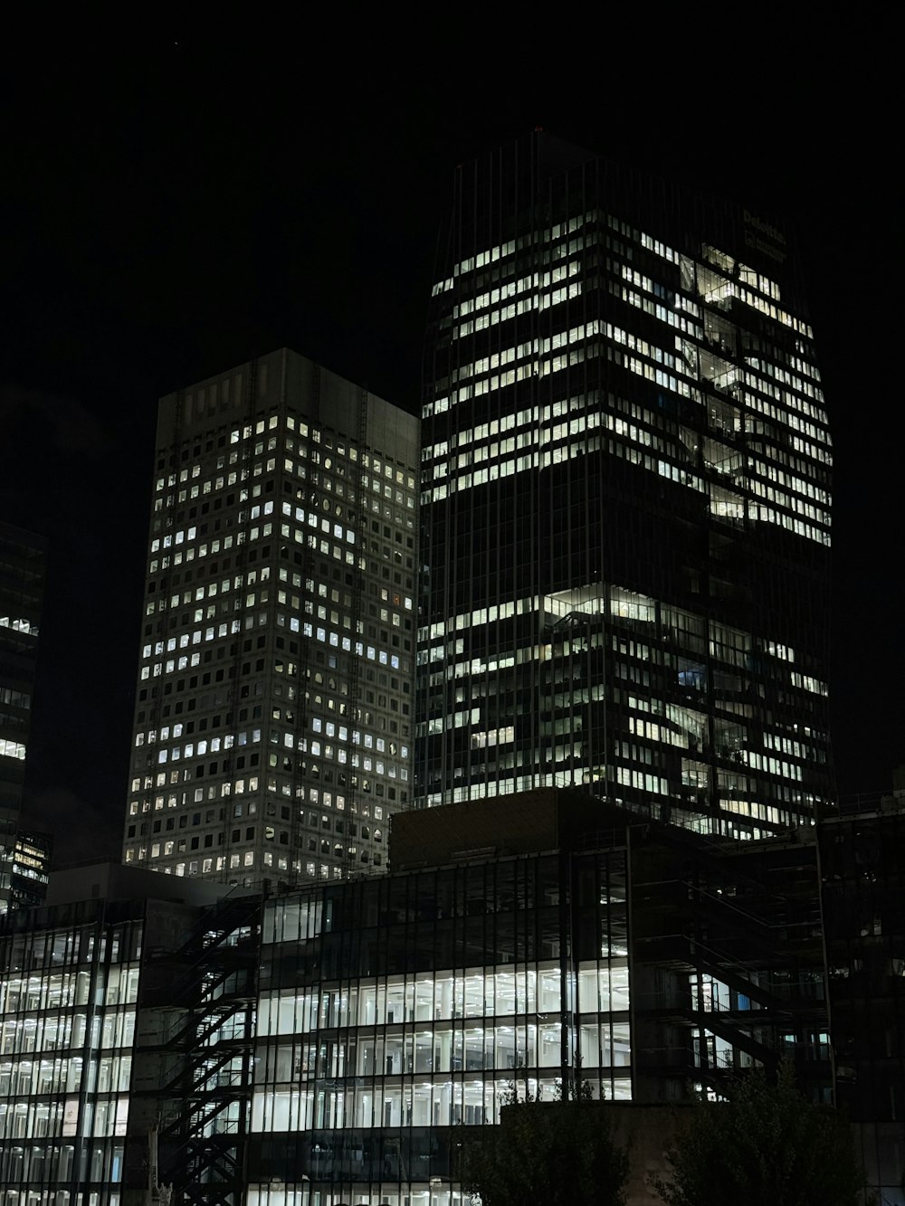 a very tall building with some lights on at night